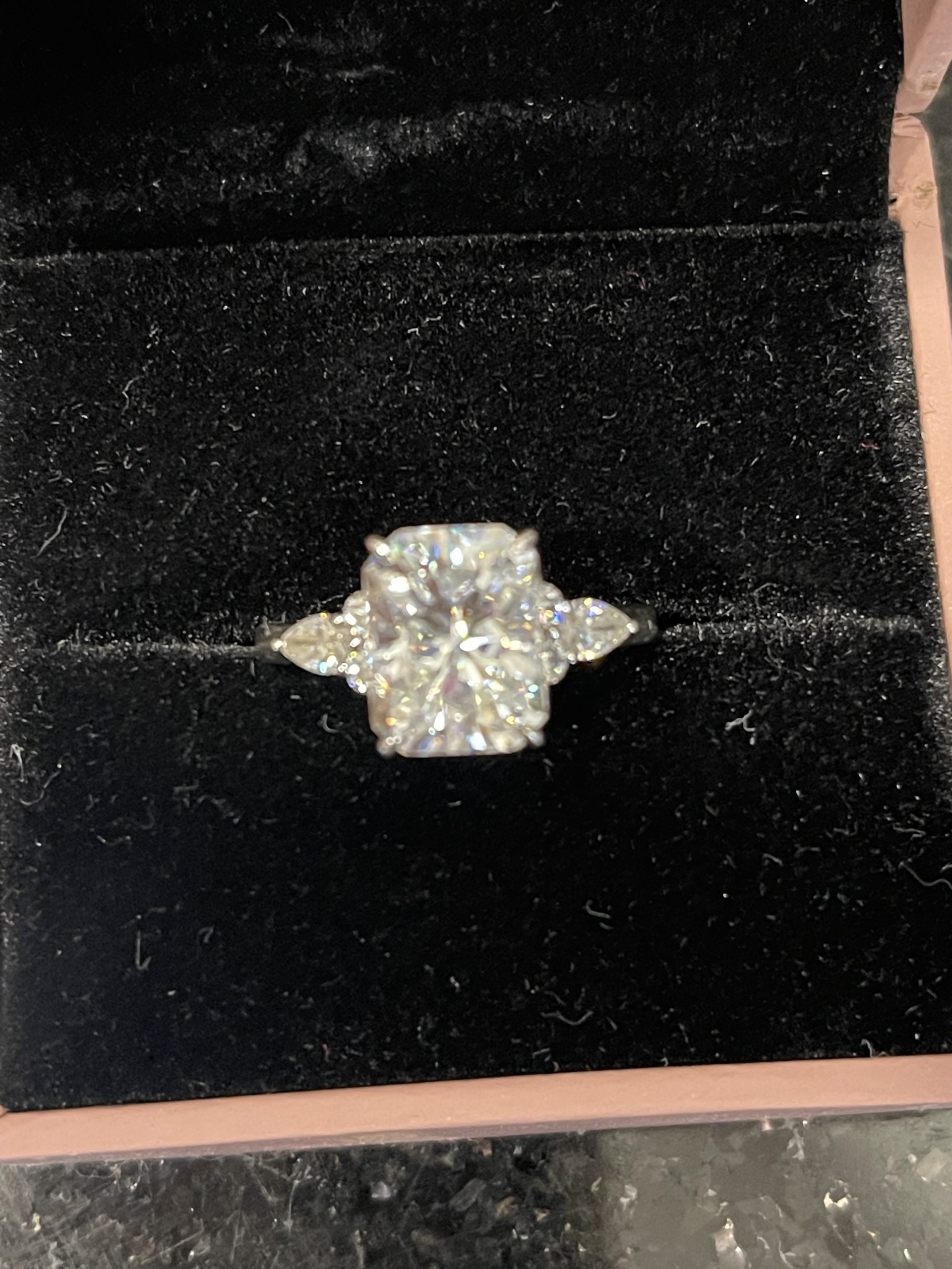 11x8mm Radiant moissanite with round and pear side stones